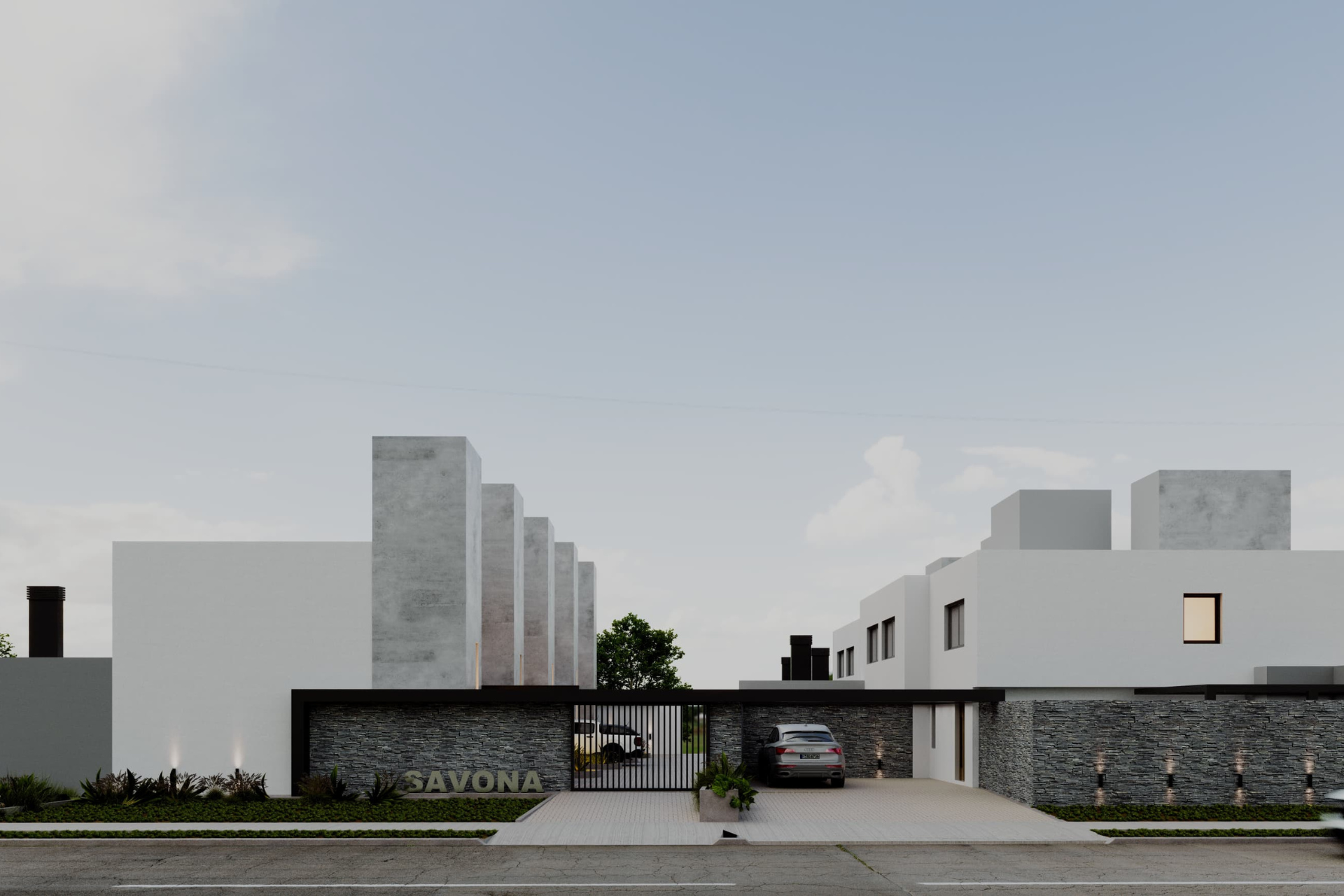 ingreso-housing-savona Espacios comunes con áreas verdes y senderos en el housing.